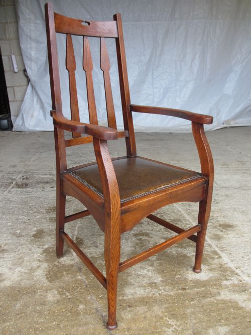 Arts & Crafts Oak Splat Back Carver Open Armchair with Spear Shaped Splats, Shaped Arms and Forelegs with Turned Tapering Feet, Box Stretcher and Studded Padded Leather Seat (Circa 1900)
