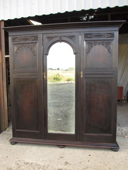 Edwardian Carved Dark Oak Triple Mirror Door Wardrobe