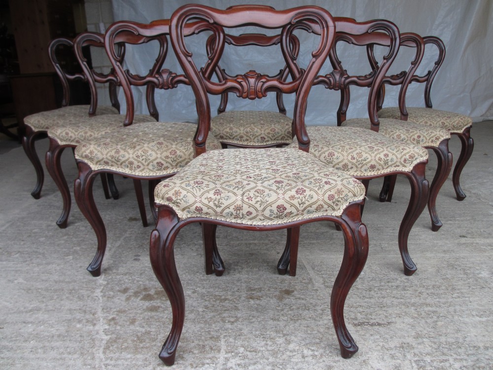 Set of 8 Victorian mahogany shaped balloon back dining chairs with scroll carved bar,overstuffed serpentine fronted seats set on carved cabriole forelegs