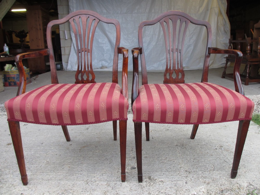 Pair of Georgian mahogany armchairs with shaped crest rail and pierced splat, overstuffed upholstered  seats on tapering forelegs