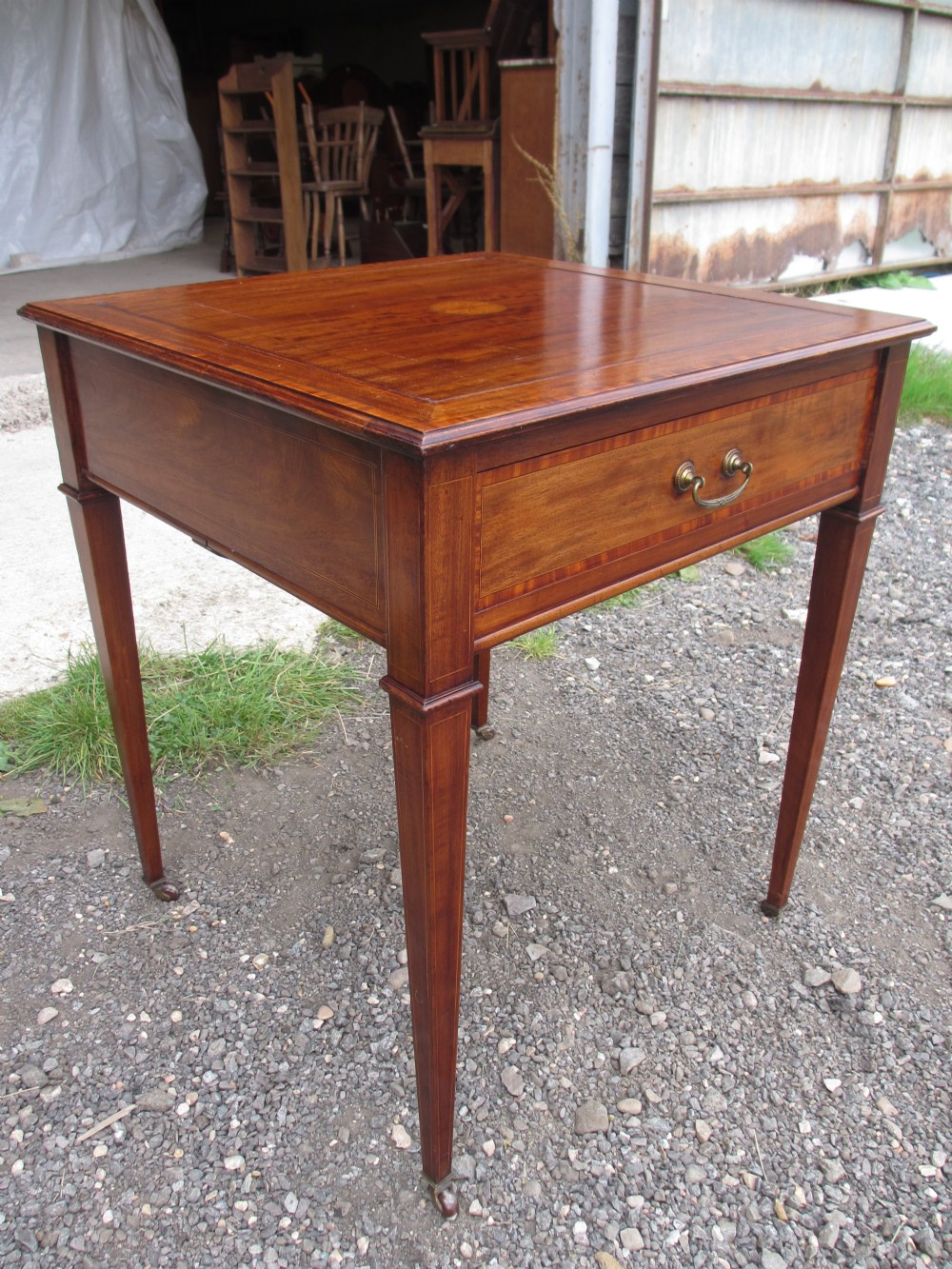 Quality Edwardian mahogany games table with reversible inlaid top and baize playing surface under, revealing chequer board and frieze drawer, pull out tables to sides set on inlaid tapering legs on castors