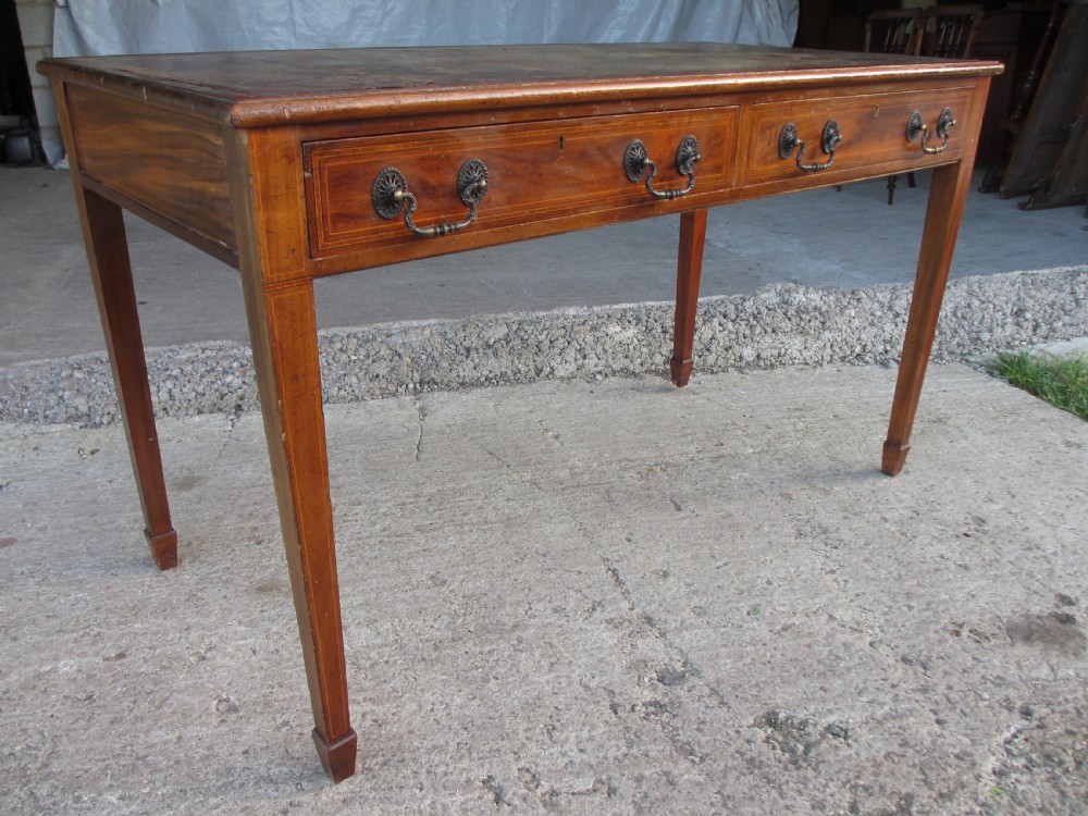 19C Mahogany Writing Library Desk with Inlaid Leather top and lined interior. Gallery top. On castors