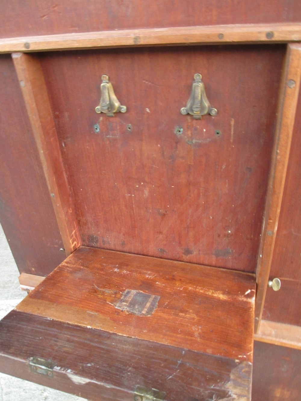 A 19th-century mahogany rectangular tilt-top dining table supported by a turned central pedestal with four splayed legs fitted with brass castors. View IX