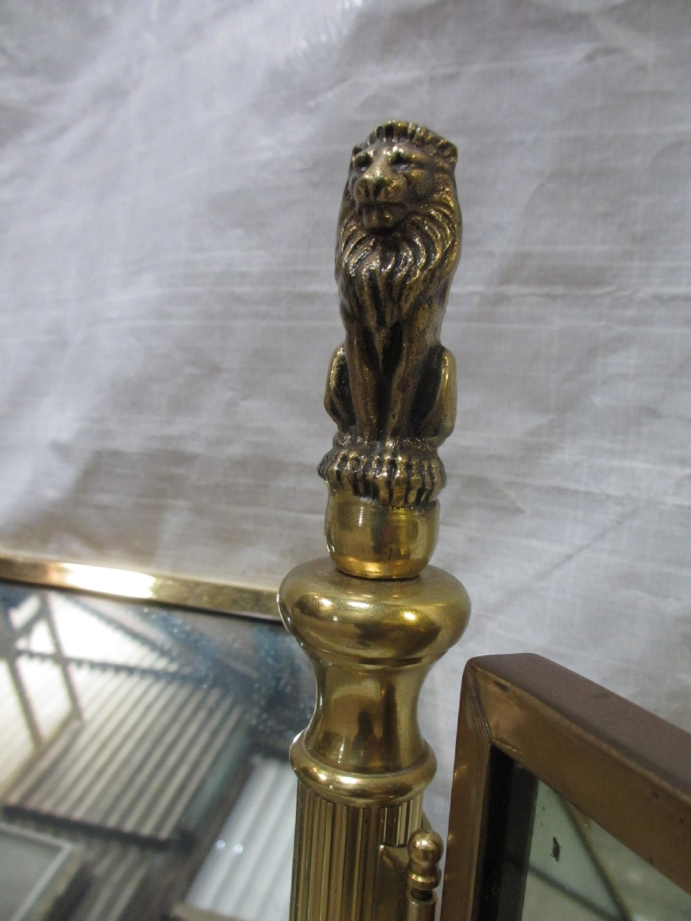 Edwardian brass triptych folding swing dressing table mirror with lion finials View IV