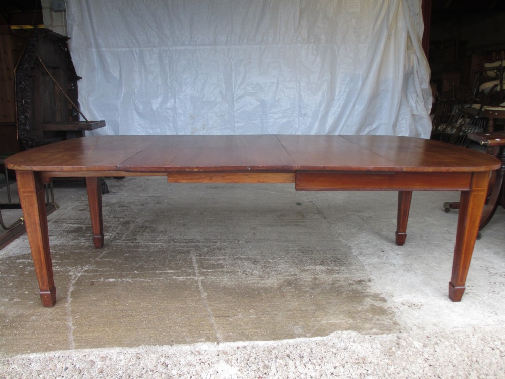 Edwardian D-end mahogany extending dining table, 2 leaves and winding handle, tapered legs and spade feet
