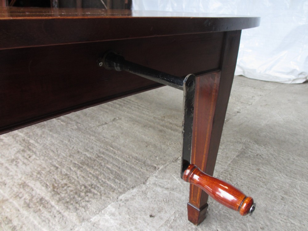 Edwardian D-end mahogany extending dining table, 2 leaves and winding handle, tapered legs and spade feet View III