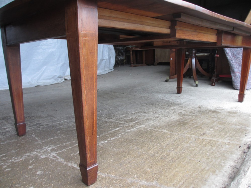 Edwardian D-end mahogany extending dining table, 2 leaves and winding handle, tapered legs and spade feet View IV