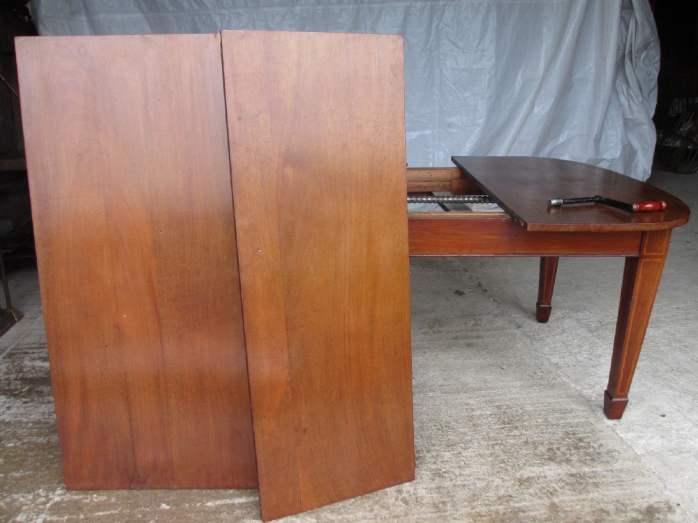 Edwardian D-end mahogany extending dining table, 2 leaves and winding handle, tapered legs and spade feet View X