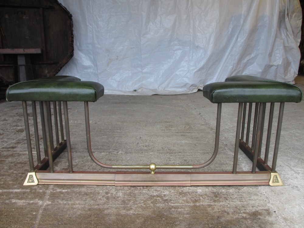 Edwardian brass and upholstered club fire fender with cylindrical uprights 
