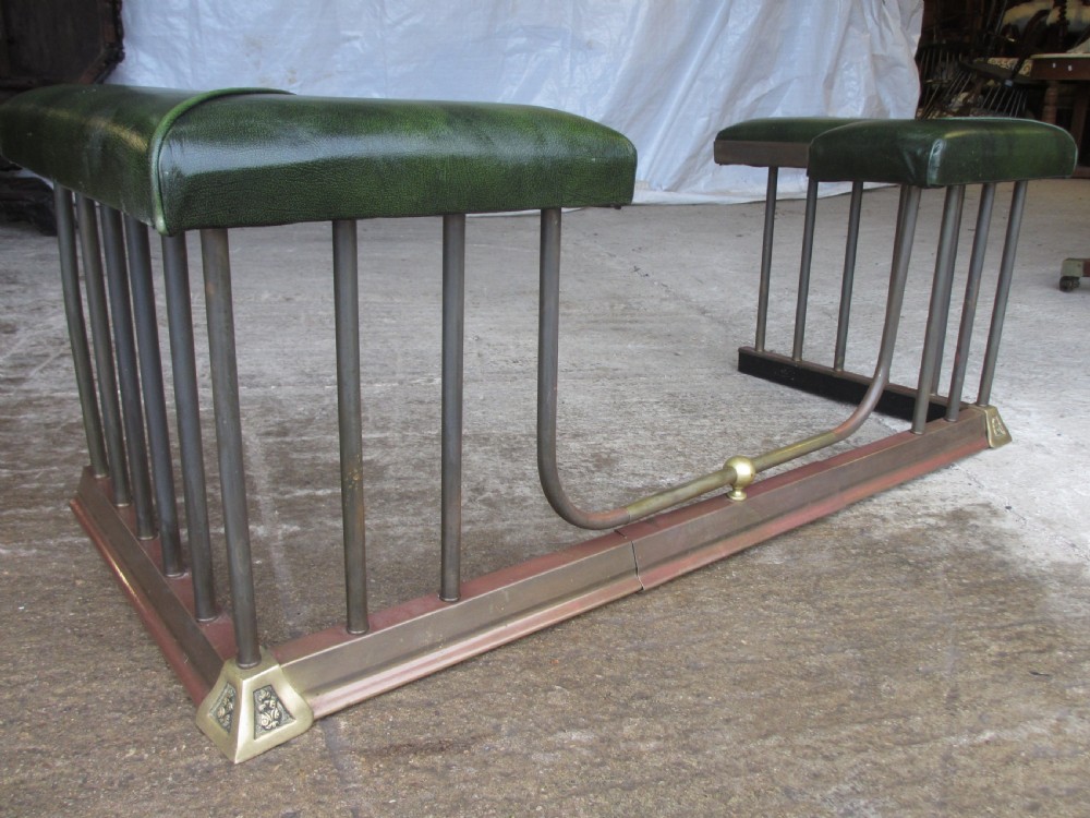 Edwardian brass and upholstered club fire fender with cylindrical uprights  View II