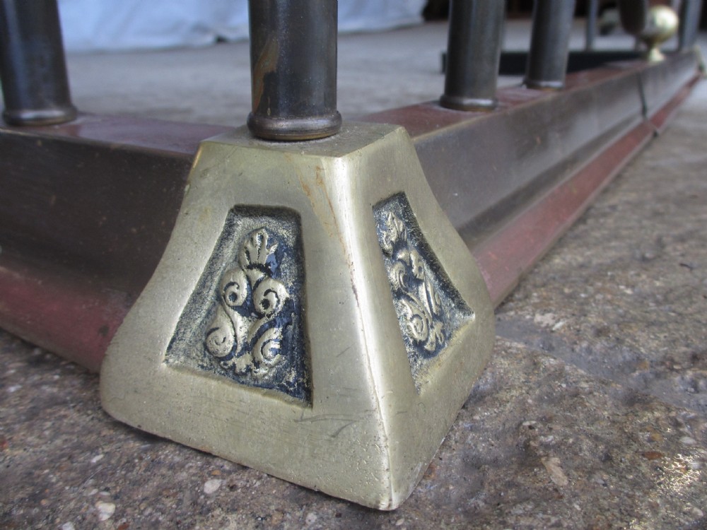 Edwardian brass and upholstered club fire fender with cylindrical uprights  View V