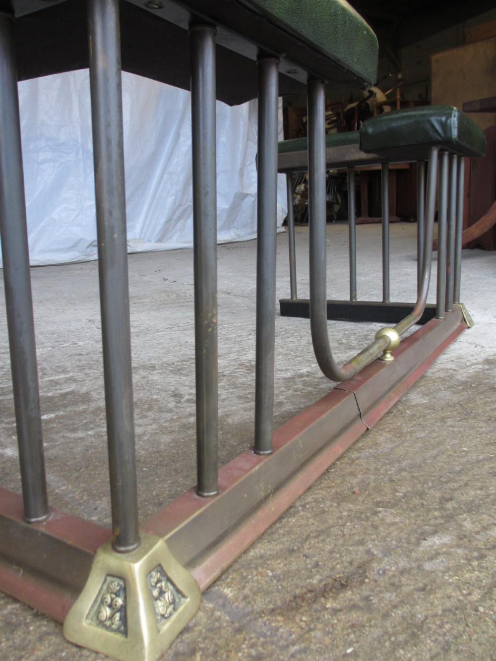 Edwardian brass and upholstered club fire fender with cylindrical uprights  View VI