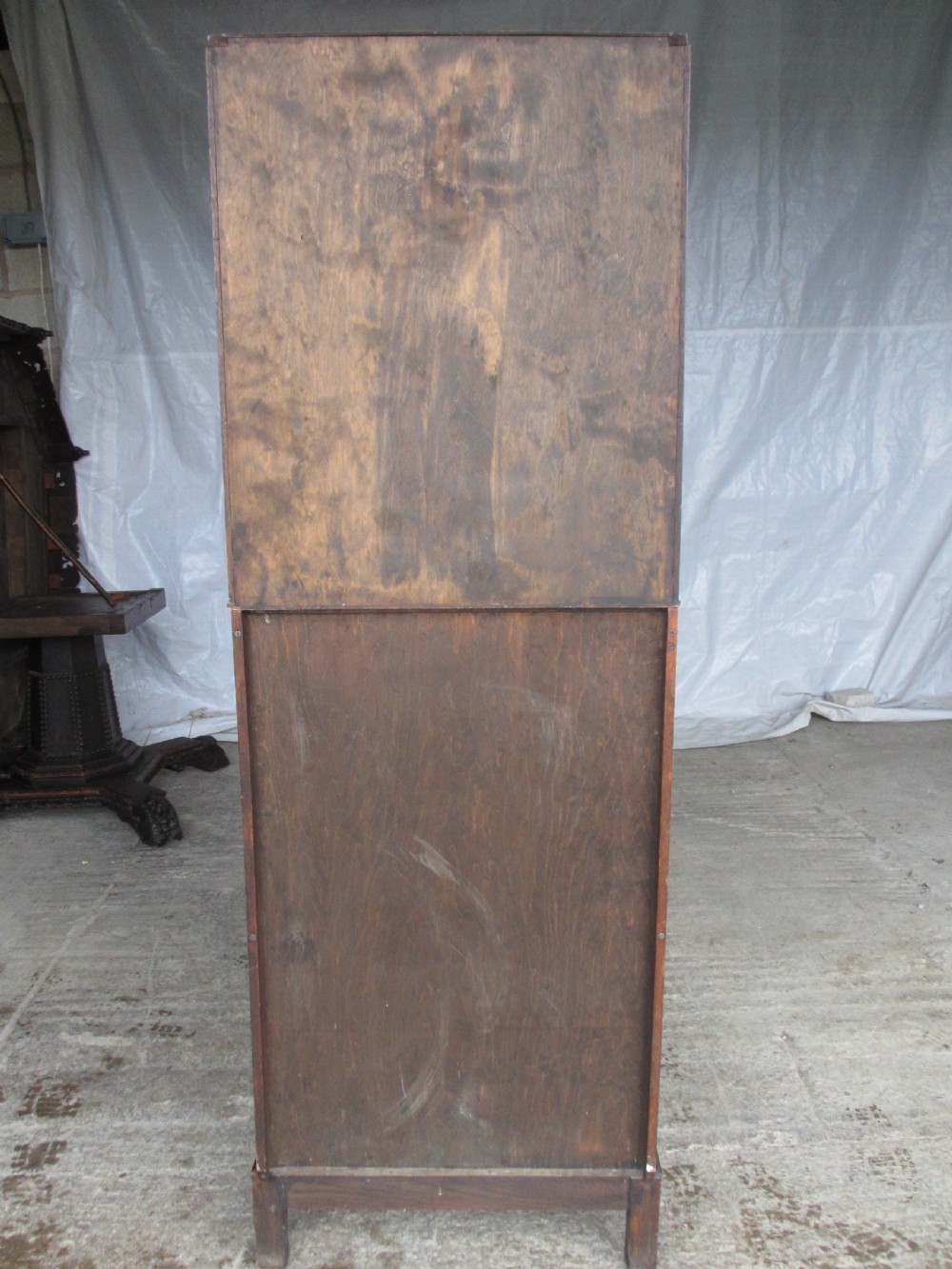A narrow Edwardian oak bureau bookcase with twin glazed doors on the upper section above a fall-front writing desk and three drawers with wooden bun handles. View XV