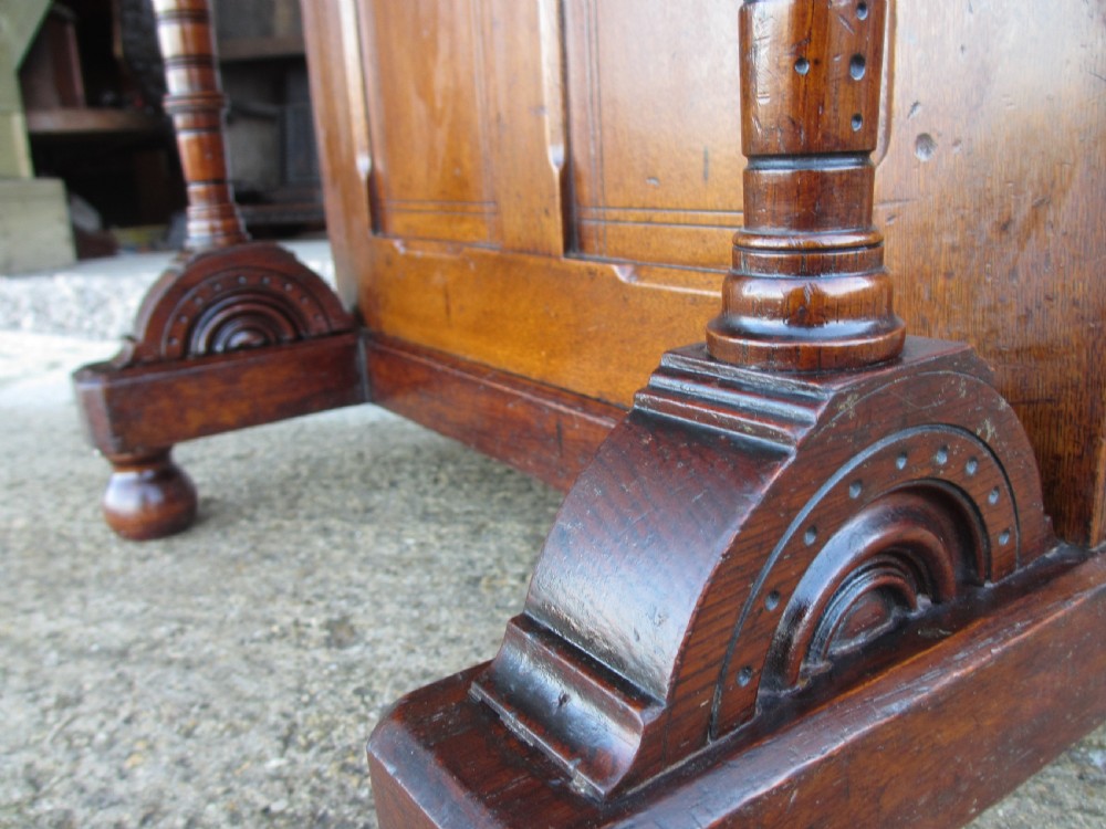 A Victorian oak davenport desk featuring a green leather writing surface, brass gallery rail, and turned front columns. View IX