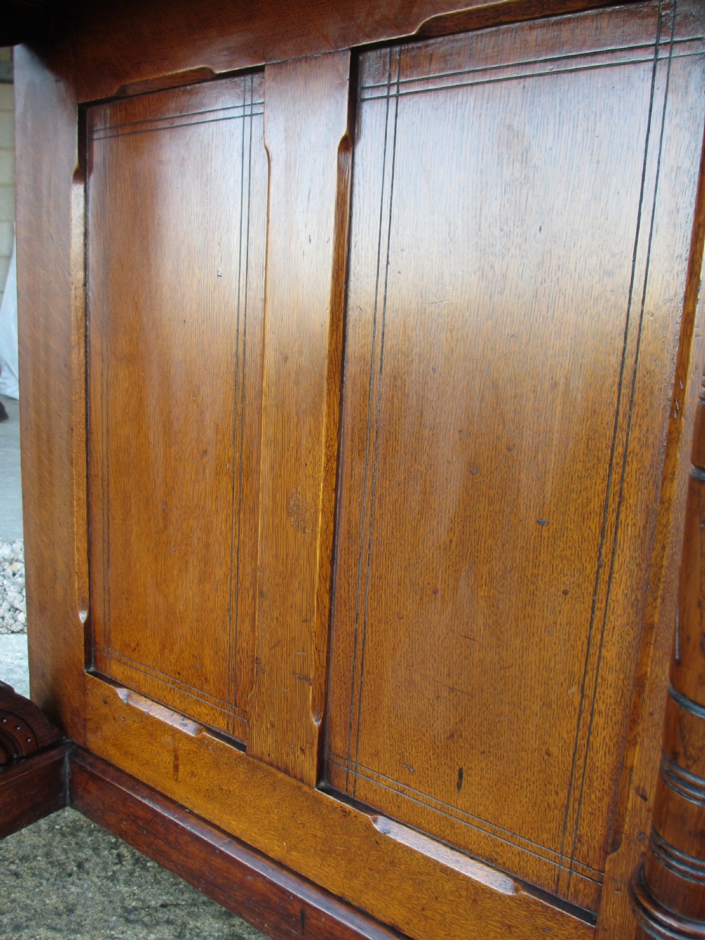 A Victorian oak davenport desk featuring a green leather writing surface, brass gallery rail, and turned front columns. View XIII