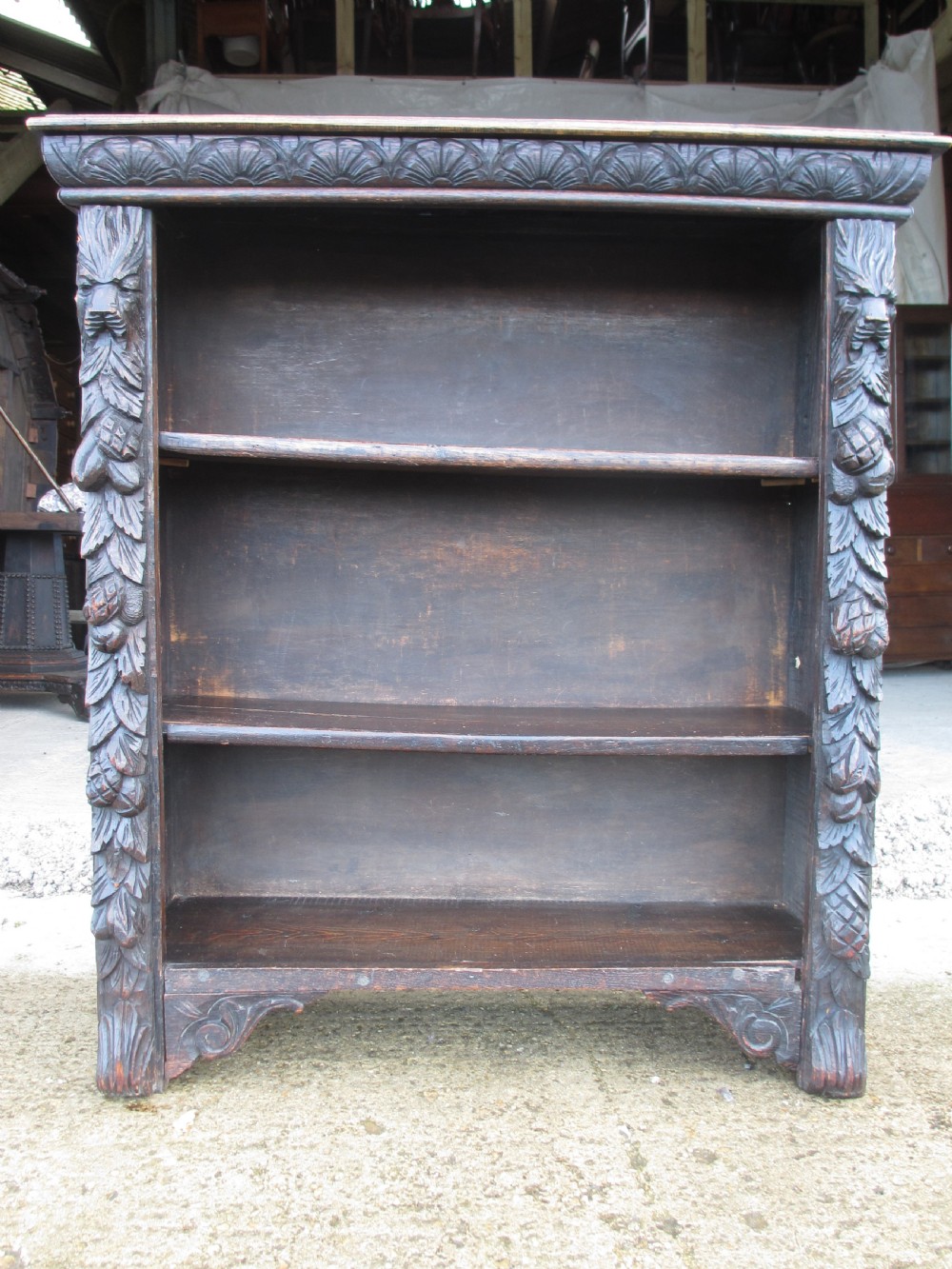 Victorian Oak carved open bookcase with adjustable shelves, lion heads and floral carved columns  View II
