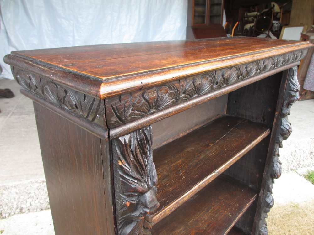 Victorian Oak carved open bookcase with adjustable shelves, lion heads and floral carved columns  View III