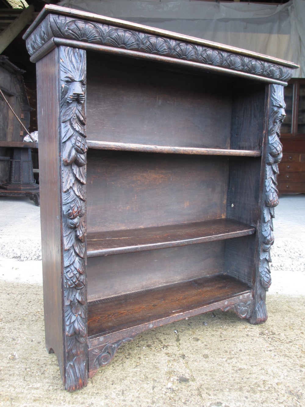 Victorian Oak carved open bookcase with adjustable shelves, lion heads and floral carved columns  View V