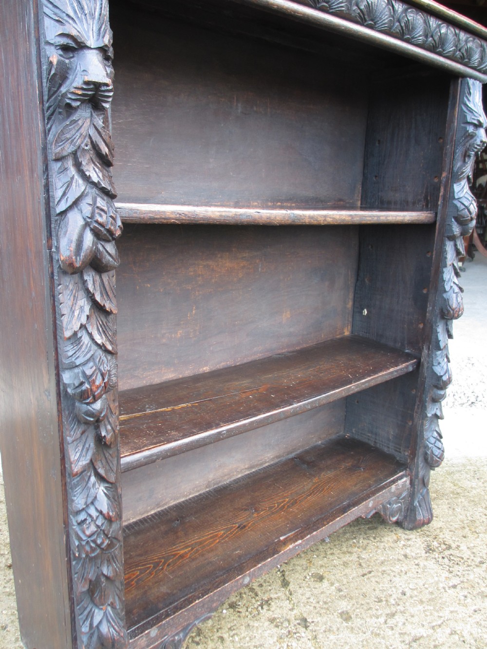 Victorian Oak carved open bookcase with adjustable shelves, lion heads and floral carved columns  View VI