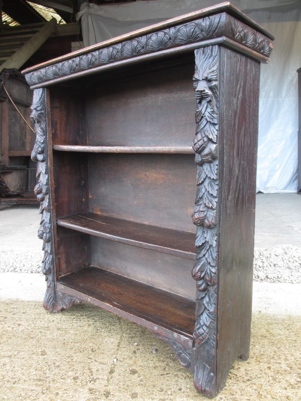 Victorian Oak carved open bookcase with adjustable shelves, lion heads and floral carved columns  View X