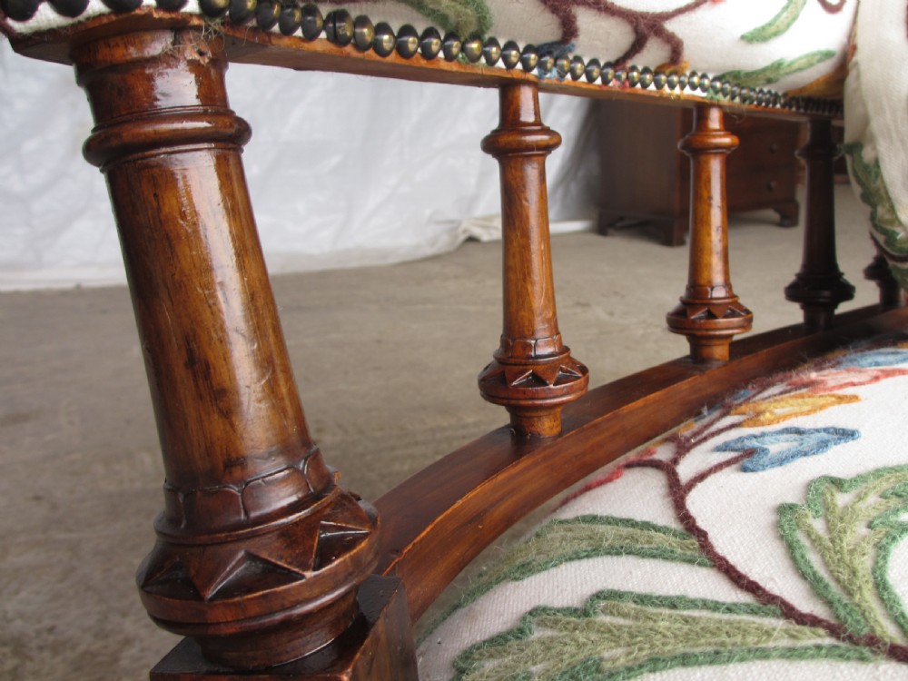 Victorian walnut upholstered window settee with turned and carved crest rail supports, turned forelegs, on castors  View IV