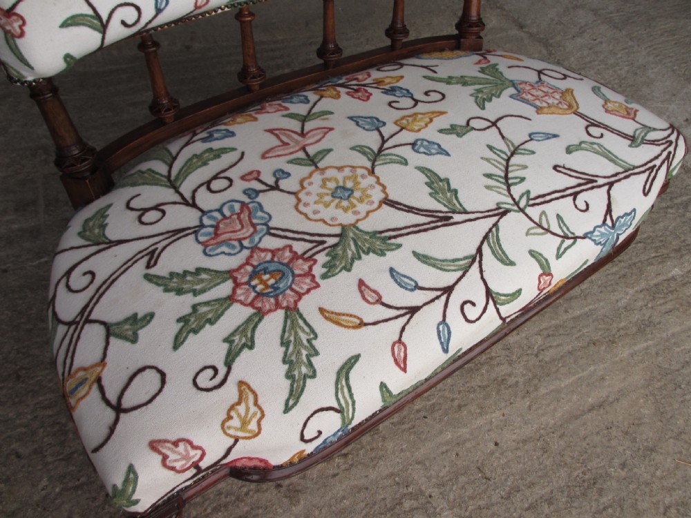 Victorian walnut upholstered window settee with turned and carved crest rail supports, turned forelegs, on castors  View VII