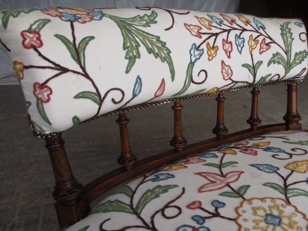Victorian walnut upholstered window settee with turned and carved crest rail supports, turned forelegs, on castors  View IX