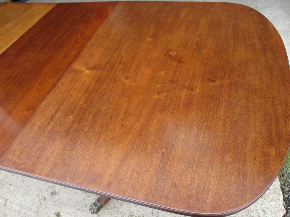 19th century mahogany extending twin tripod d-end dining table with brass paw castors with 2 leaves View V