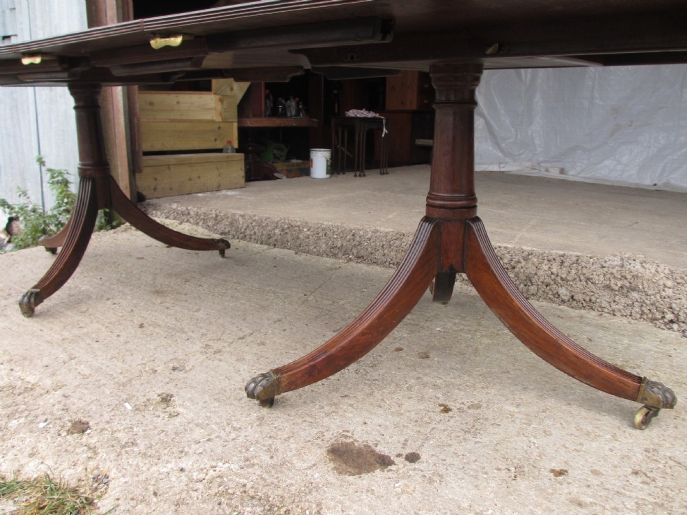 19th century mahogany extending twin tripod d-end dining table with brass paw castors with 2 leaves View VI