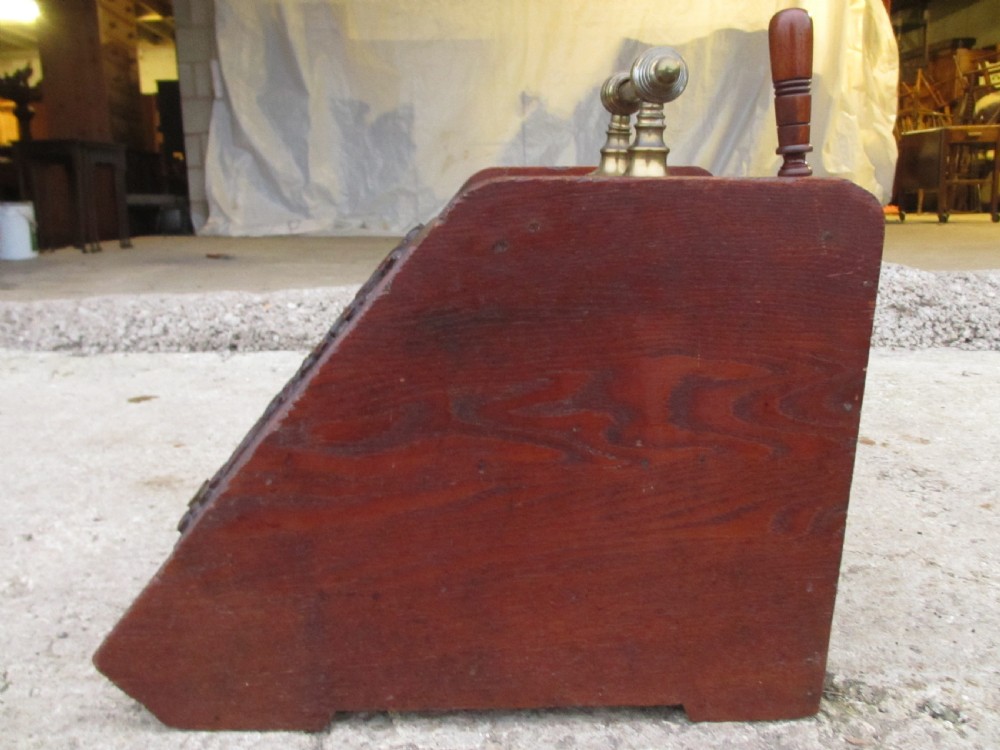 A Victorian dark oak purdonium coal box with a slanted front featuring a relief-carved acanthus leaf panel and a top brass handle. View VIII