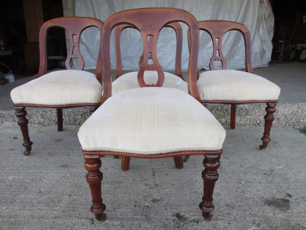 Set of 4 Victorian mahogany arched splat back dining chairs with overstuffed seats on turned forelegs