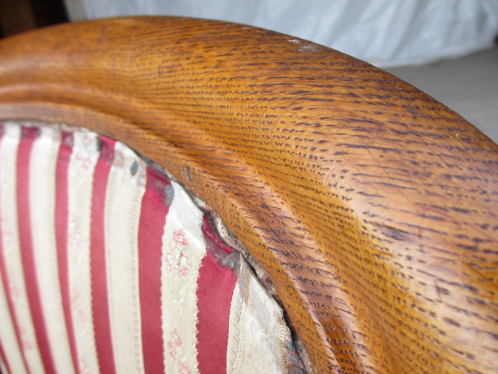 A pair of 19th-century oak balloon back dining chairs featuring red and cream striped upholstery, carved scroll details, and cabriole legs. View III