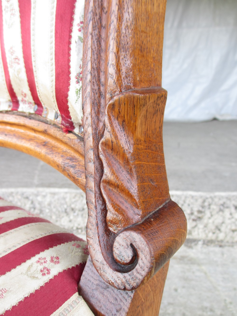A pair of 19th-century oak balloon back dining chairs featuring red and cream striped upholstery, carved scroll details, and cabriole legs. View VI