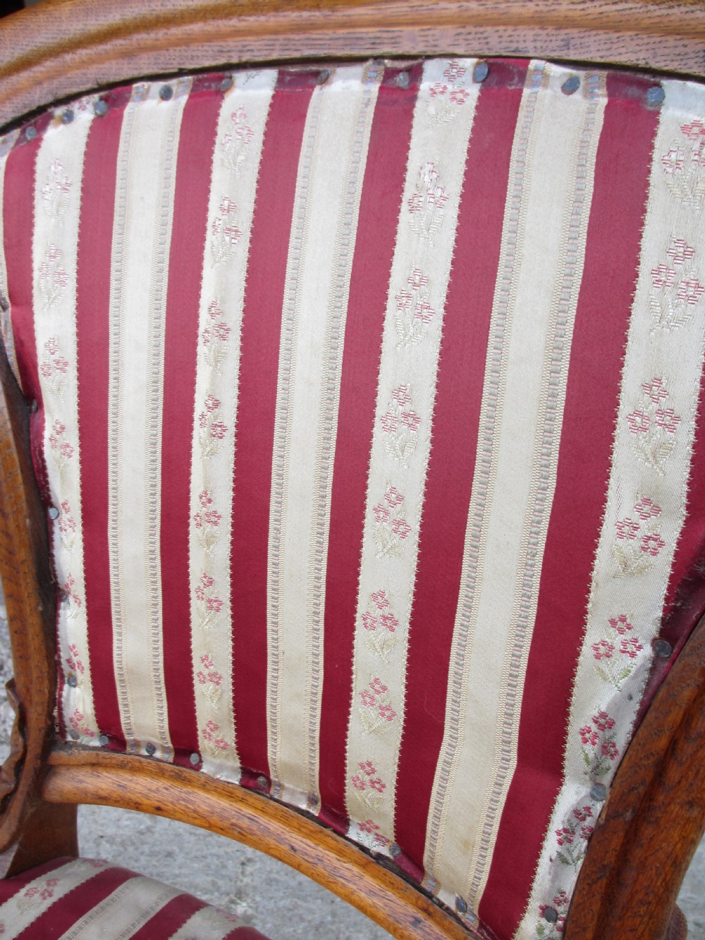 A pair of 19th-century oak balloon back dining chairs featuring red and cream striped upholstery, carved scroll details, and cabriole legs. View VII