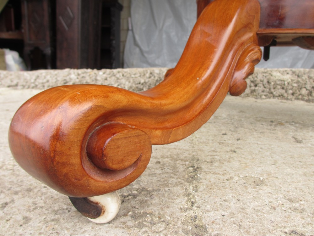 Victorian mahogany circular tilt top table with tripod scrolled legs on castors  View IV