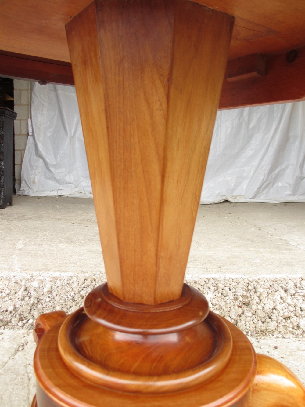 Victorian mahogany circular tilt top table with tripod scrolled legs on castors  View V