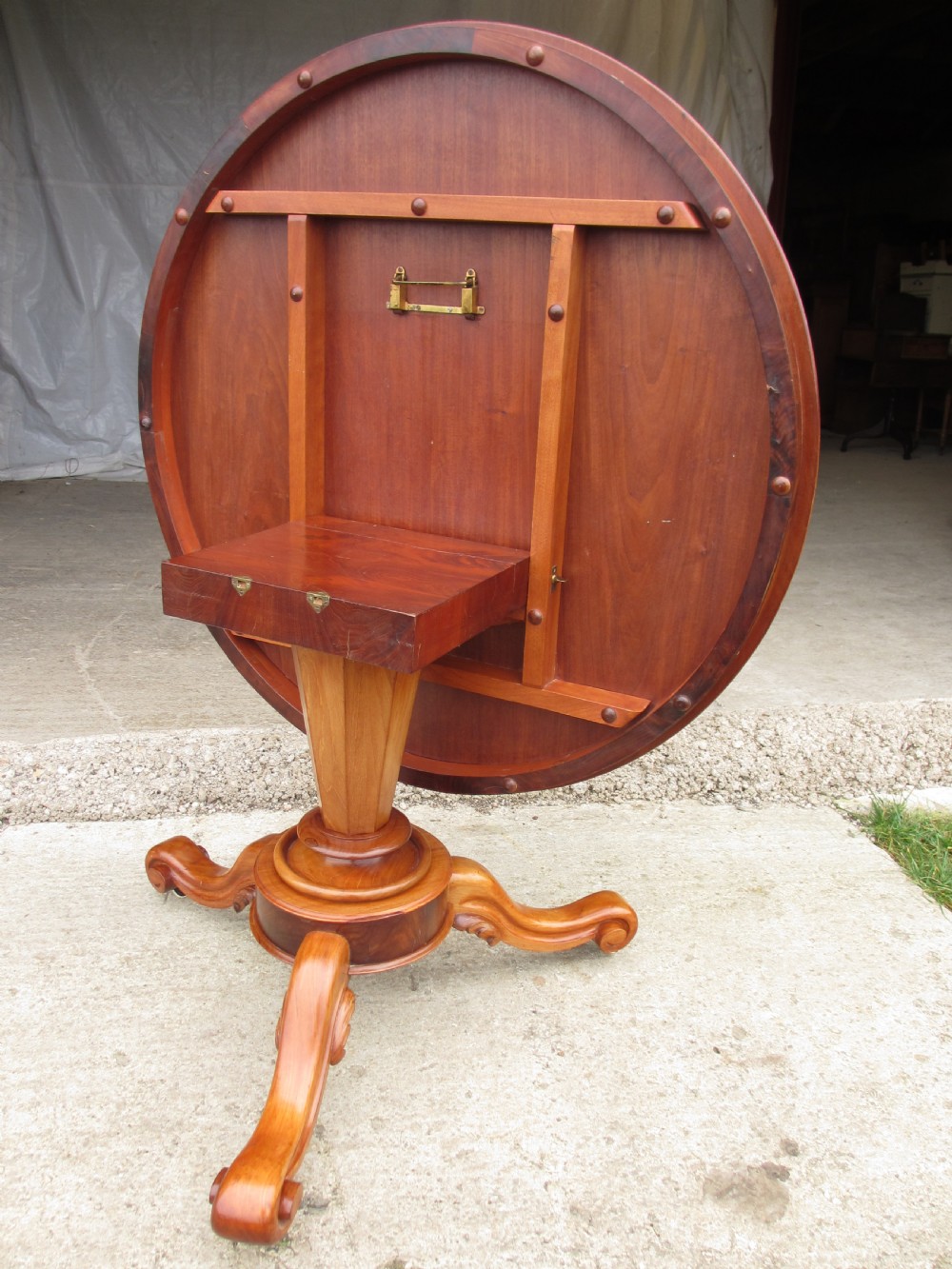 Victorian mahogany circular tilt top table with tripod scrolled legs on castors  View VII