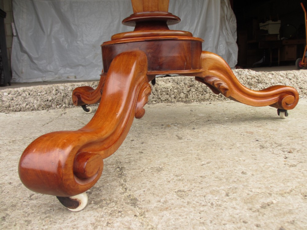 Victorian mahogany circular tilt top table with tripod scrolled legs on castors  View VIII