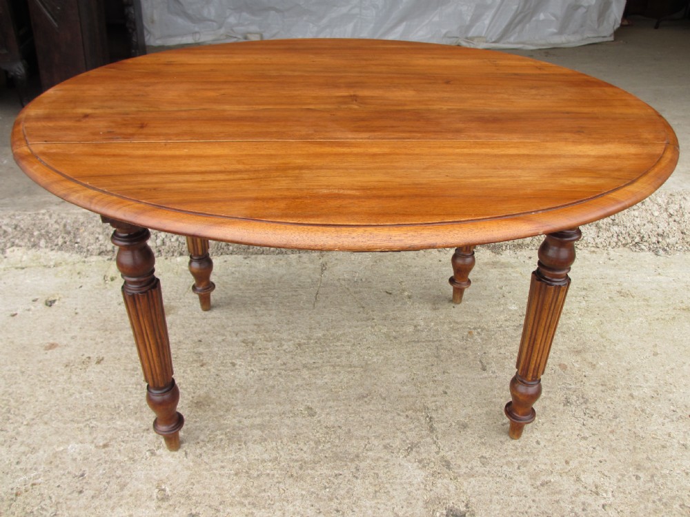 Victorian mahogany circular top drop leaf dining table turned reeded supports View III