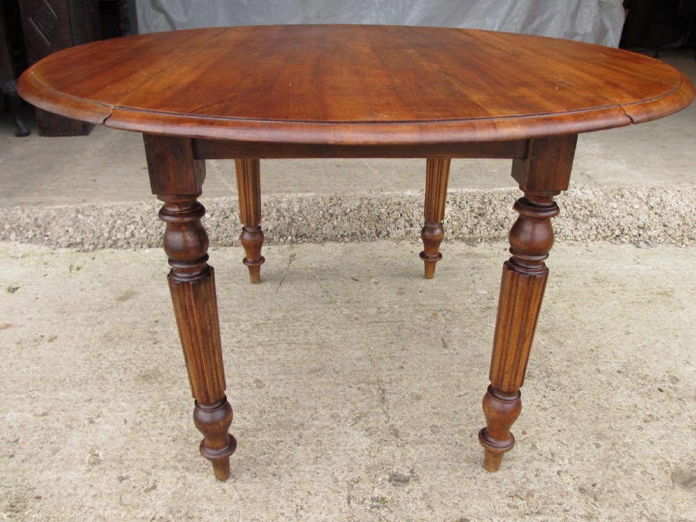 Victorian mahogany circular top drop leaf dining table turned reeded supports View IV