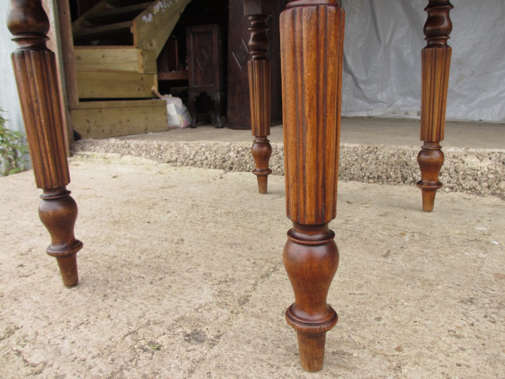 Victorian mahogany circular top drop leaf dining table turned reeded supports View VII
