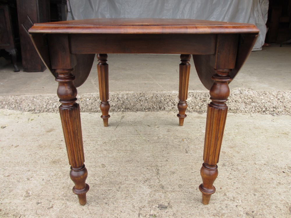 Victorian mahogany circular top drop leaf dining table turned reeded supports View XI