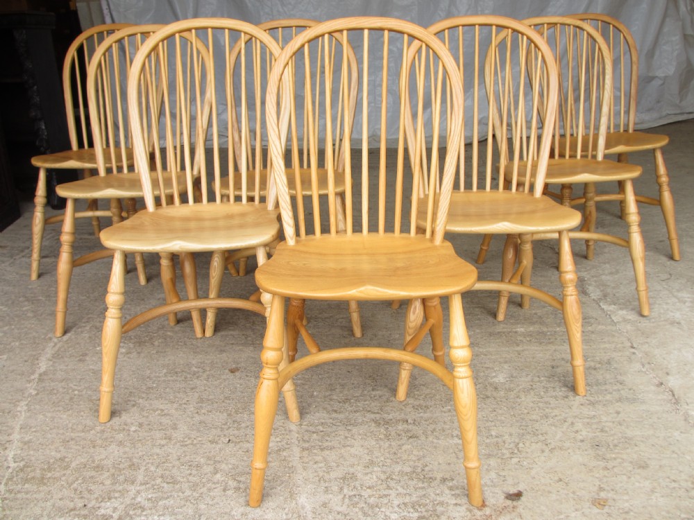 Set of eight stick back elm seated windsor dining chairs splayed supports curved stretcher c1920 View II