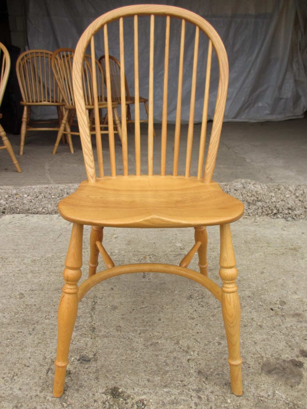 Set of eight stick back elm seated windsor dining chairs splayed supports curved stretcher c1920 View III