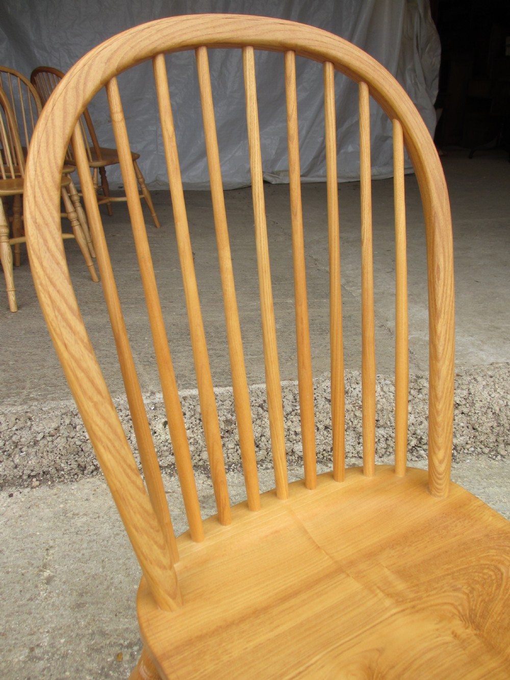 Set of eight stick back elm seated windsor dining chairs splayed supports curved stretcher c1920 View IV