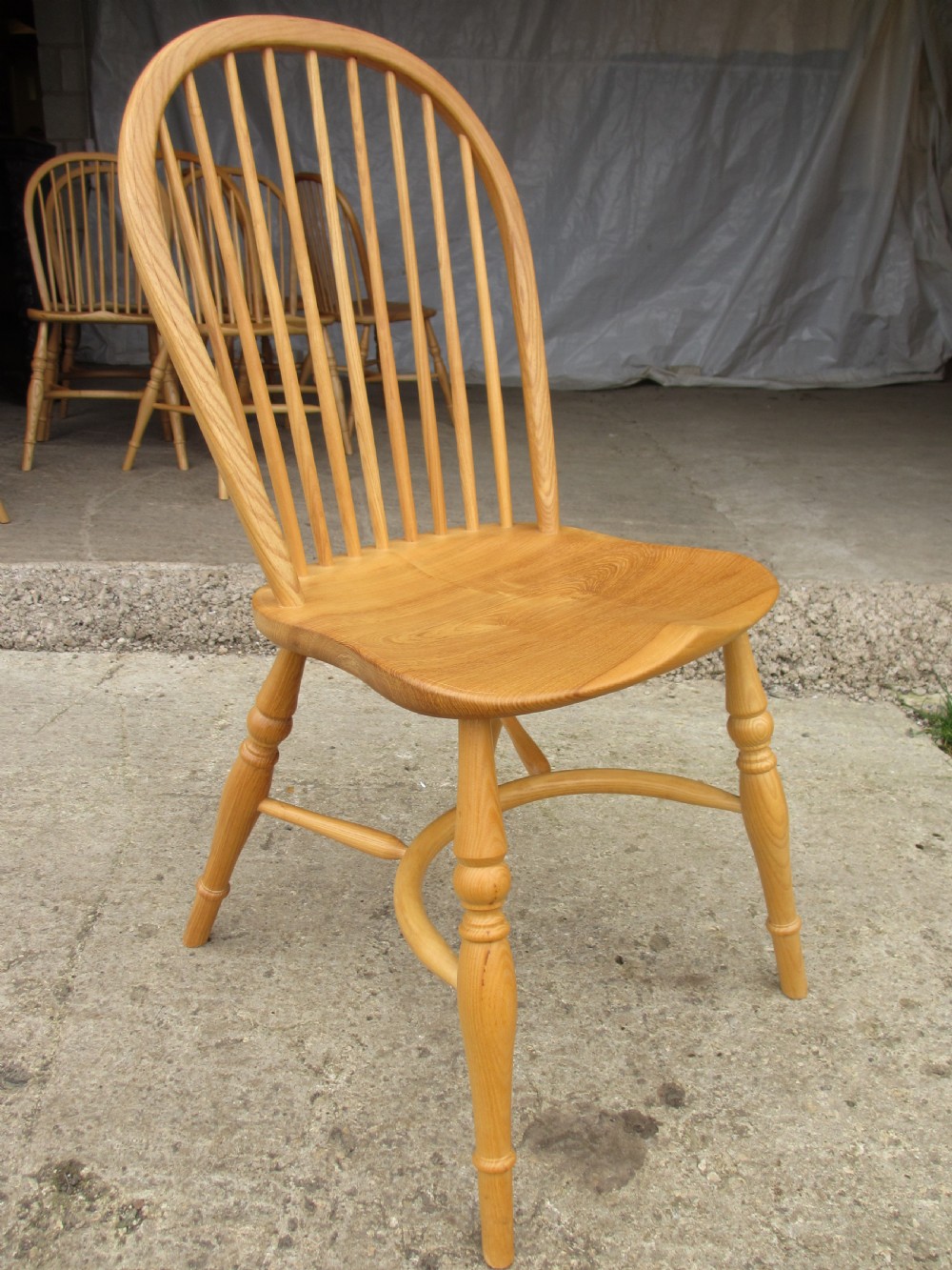 Set of eight stick back elm seated windsor dining chairs splayed supports curved stretcher c1920 View V