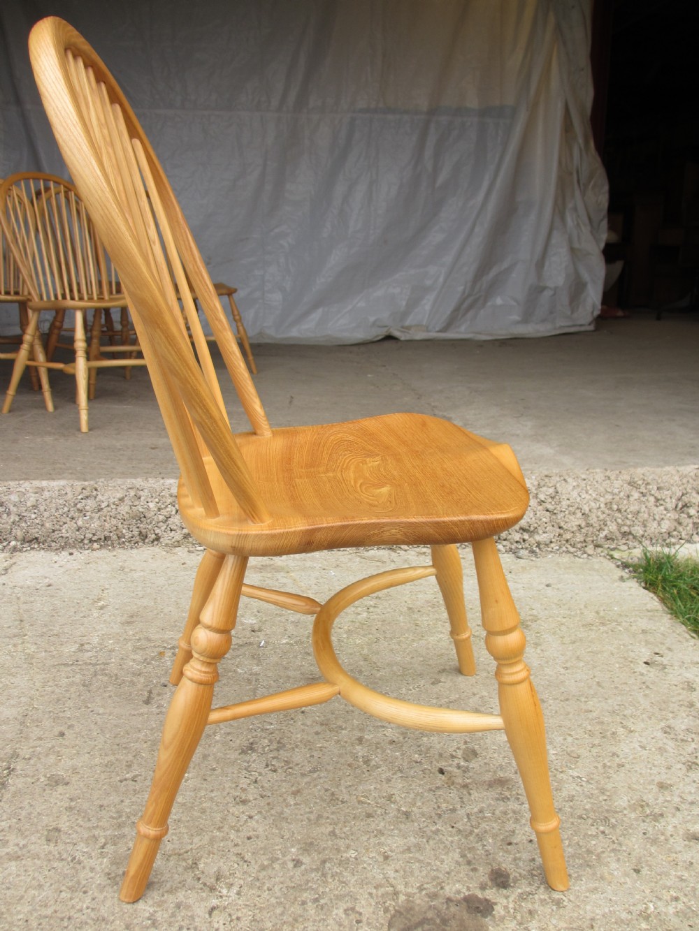 Set of eight stick back elm seated windsor dining chairs splayed supports curved stretcher c1920 View IX