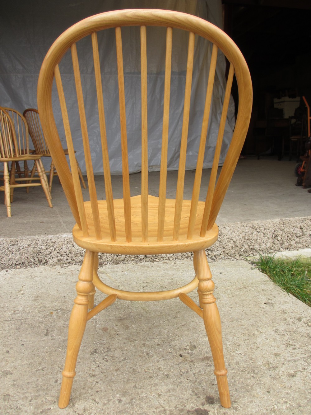 Set of eight stick back elm seated windsor dining chairs splayed supports curved stretcher c1920 View X