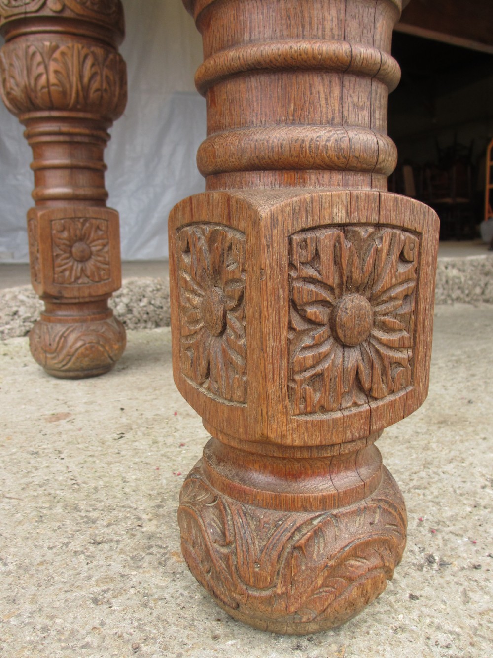 Victorian carved heavy oak dining table with lion heads and floral and leaf frieze on solid oak supports View VI