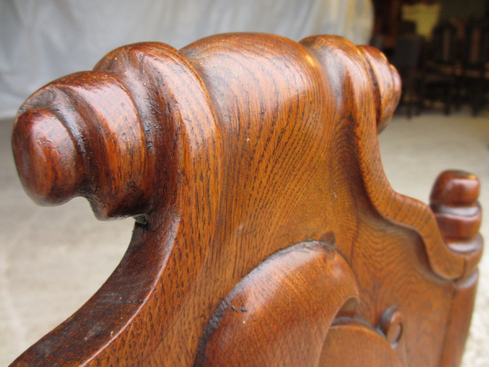 A pair of Victorian carved golden oak hall chairs featuring openwork shield backs with central cartouches, solid wooden seats, and cabriole front legs. View III